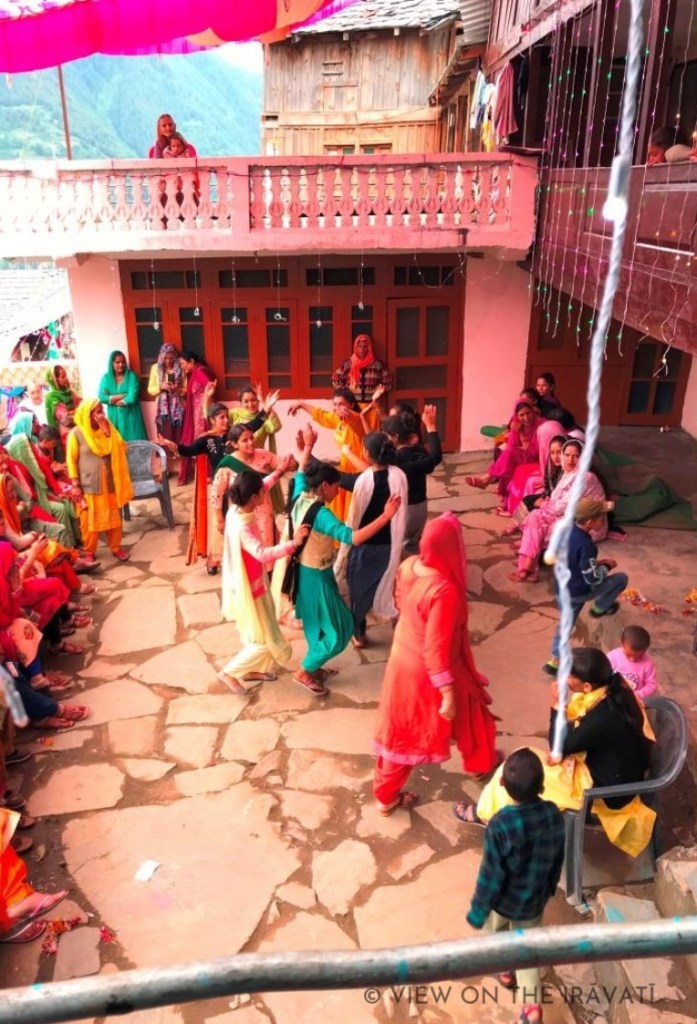 Gaddi girls dancing in a courtyard.