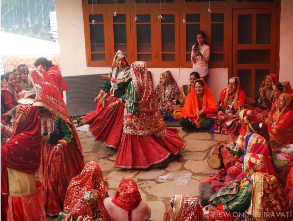 Two women dancing in luancharis during Gaddi padhua ceremony